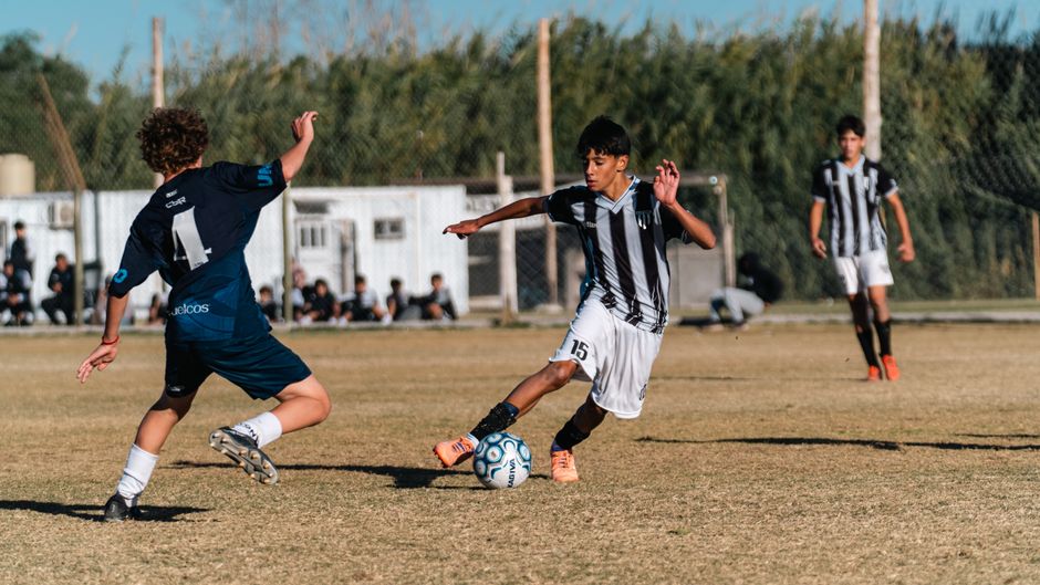 Young athletes playing football on a community field