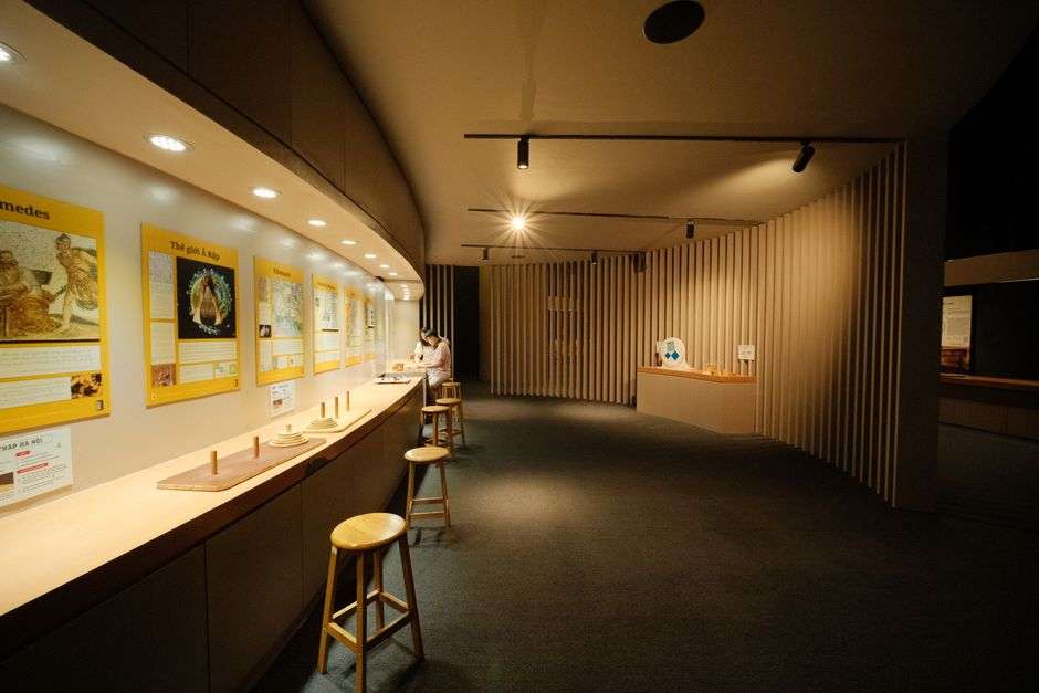 Museum gallery space with exhibit panels and soft lighting, similar to the planned Africatown Heritage House displays