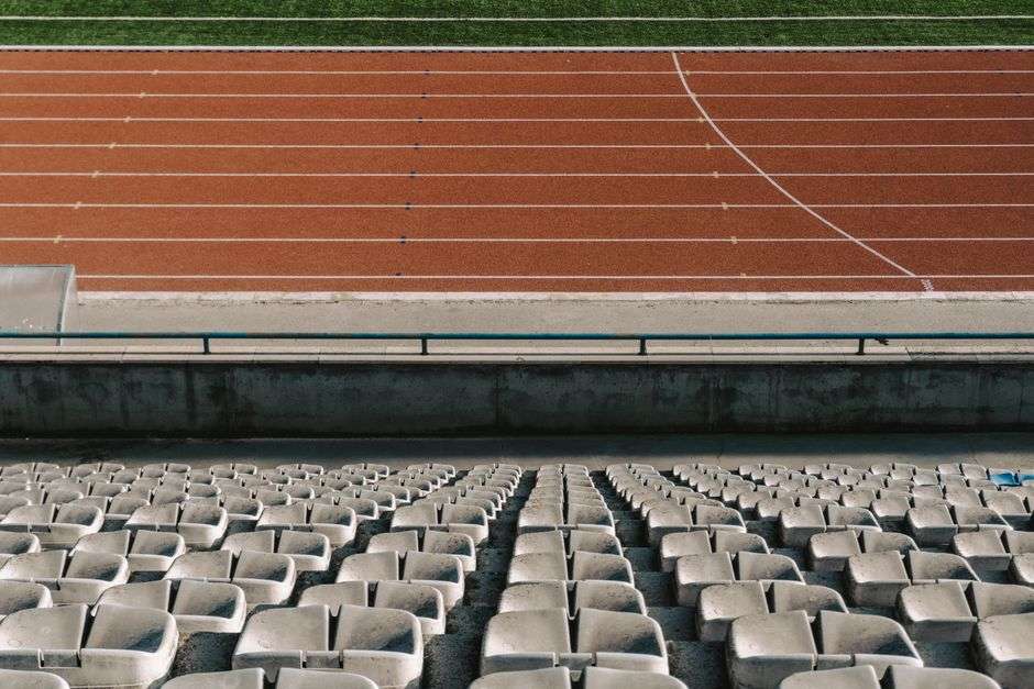 An empty stadium track and field, representing the venues hosting AHSAA All-Star Week competitions
