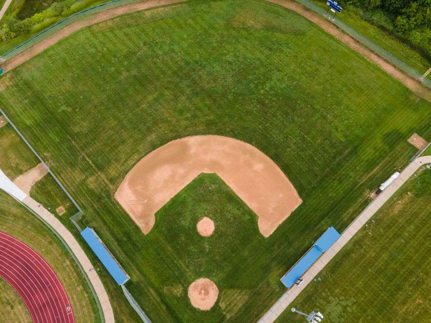 Aerial view of a high school baseball field surrounded by green grass