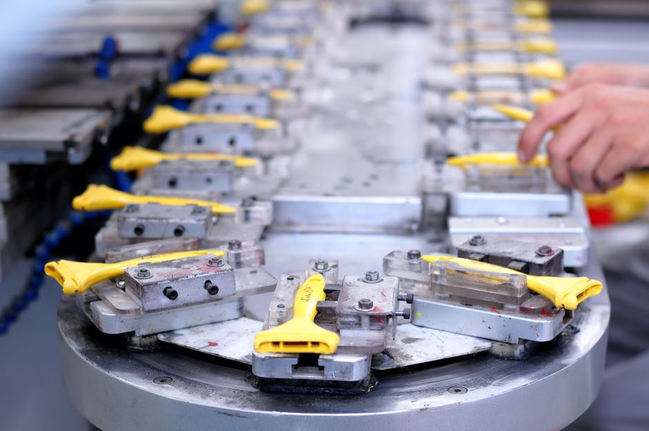 Technicians working on an aircraft assembly line similar to the Airbus A320 line in Mobile