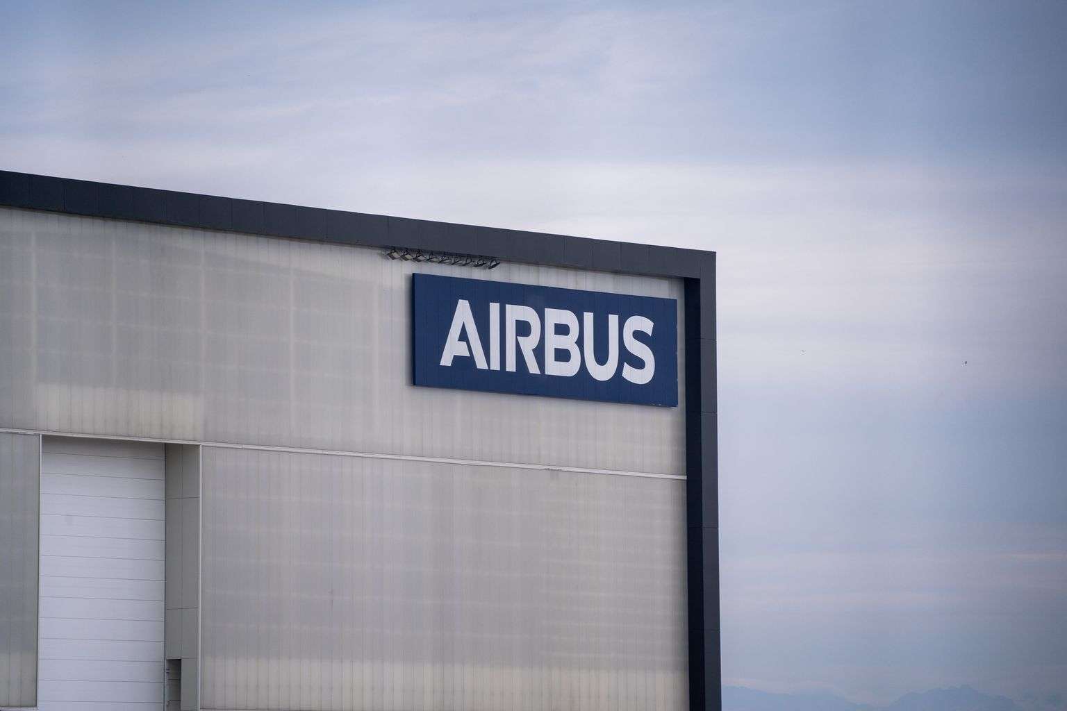 Exterior of an Airbus aircraft manufacturing facility with the company logo on the building