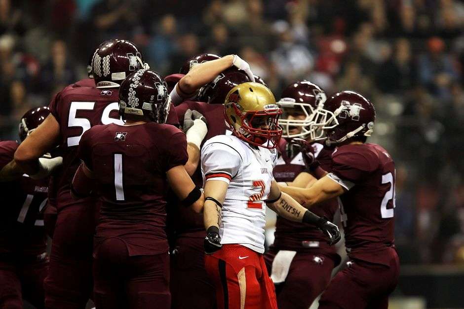 College football players in action on the field during a game
