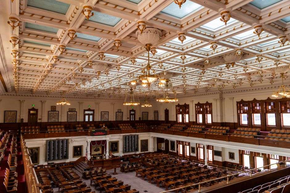 Empty legislative chamber with rows of seats where lawmakers debate and vote on bills