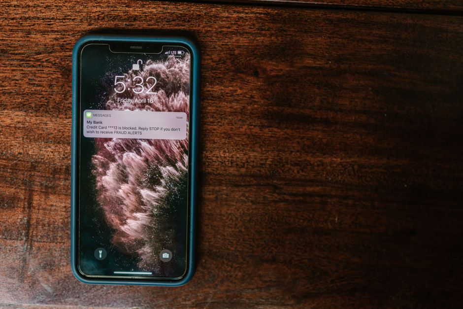 A person looking at a suspicious text message on a smartphone