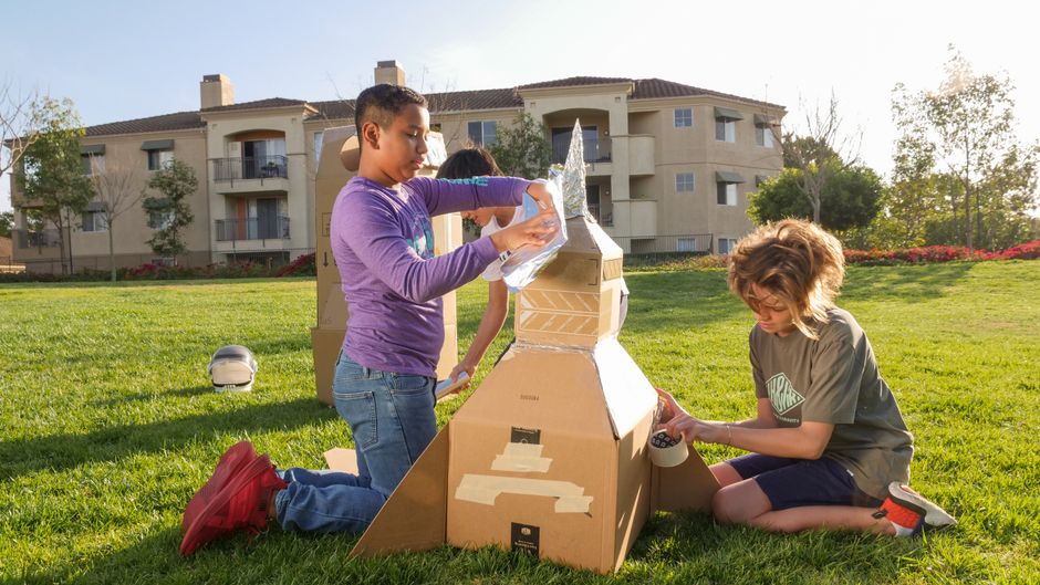 Students building and launching model rockets during a school outreach event