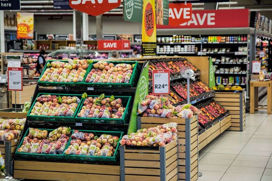 Well-stocked grocery store aisle with shelves of packaged goods
