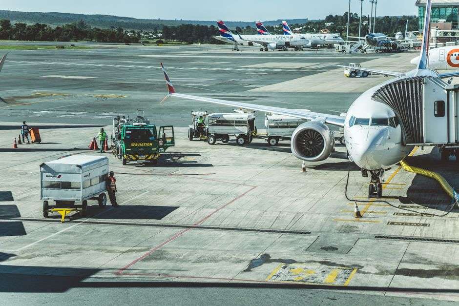 Ground crew preparing a passenger jet for departure on an airport tarmac