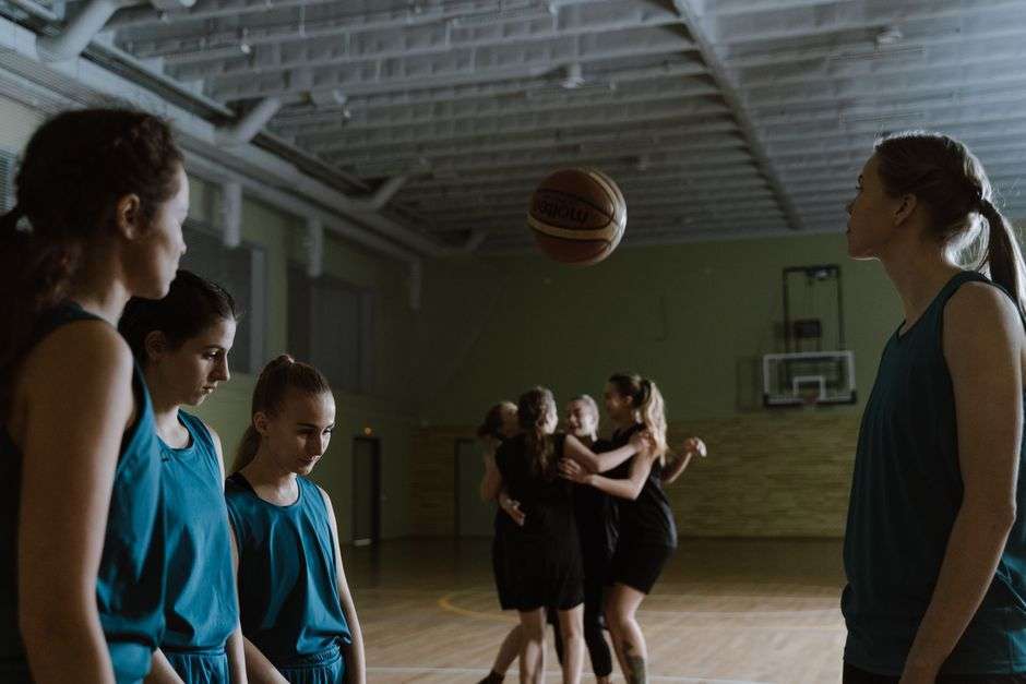 Girls high school basketball players competing during a state tournament game