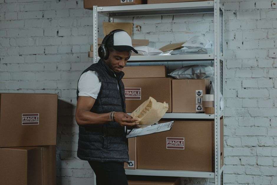 A warehouse worker sorts packages inside a distribution facility