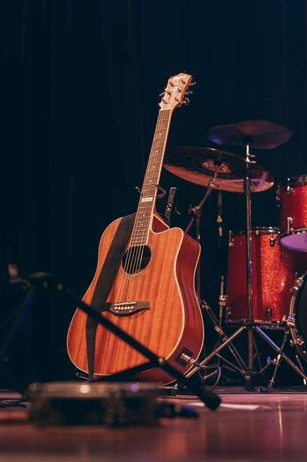Guitarist performing on stage at a country music concert