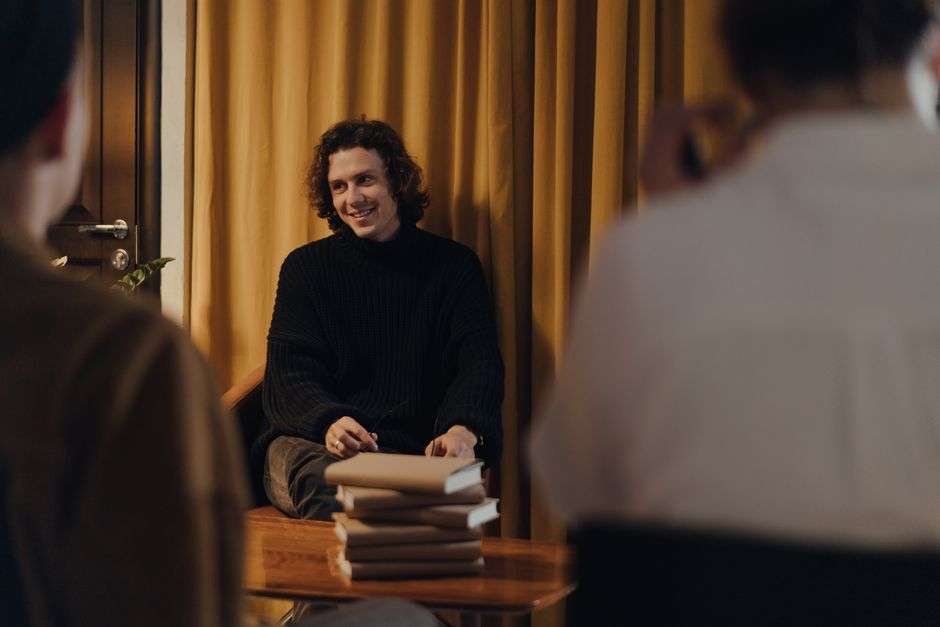 Author speaking with an audience during a book discussion event