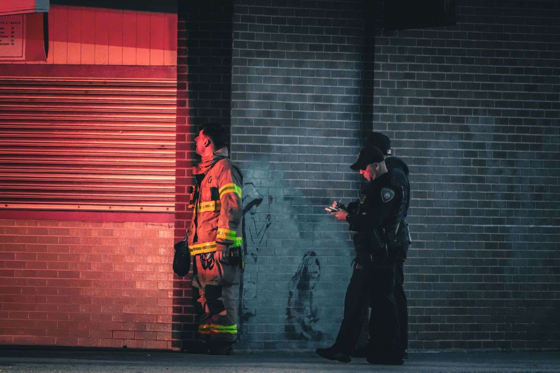 A firefighter and police officer standing together, representing public safety collaboration
