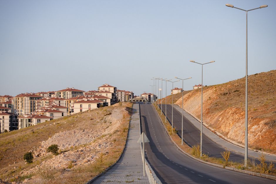 A widened four-lane highway through a growing suburban area