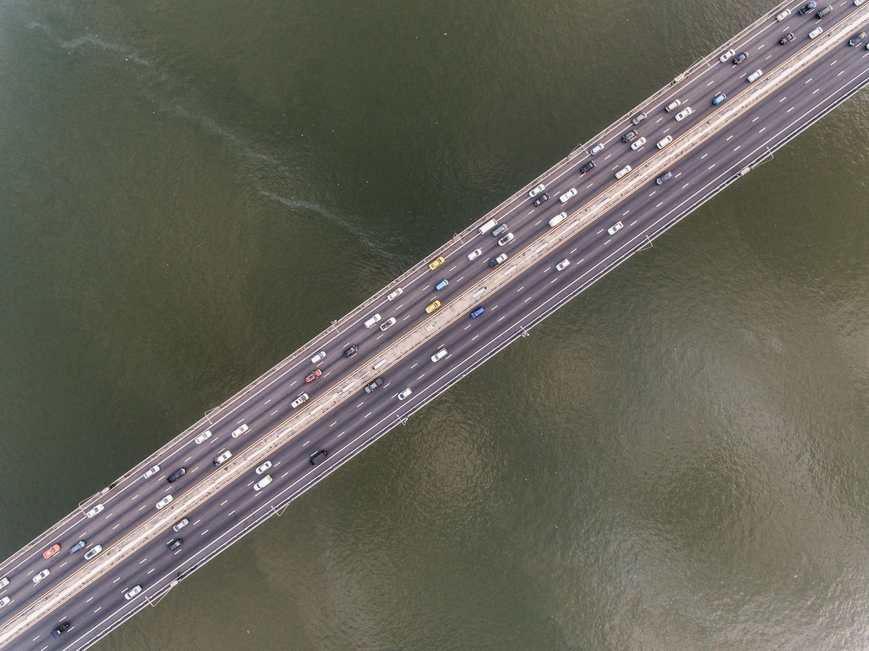 Congested highway traffic crossing a bridge over a bay