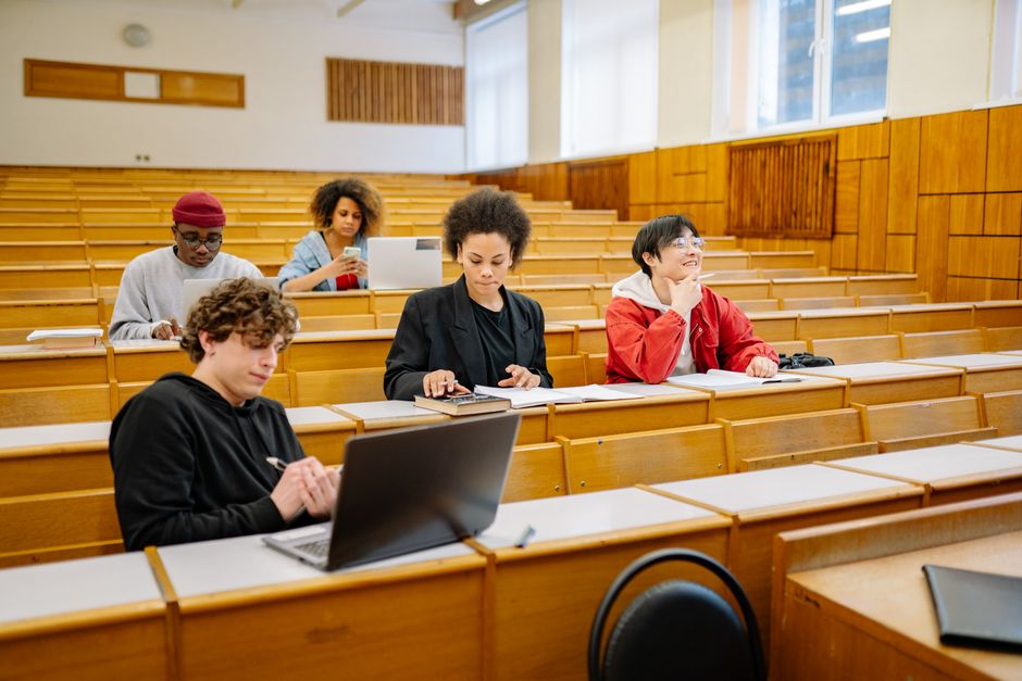 Students using school-issued laptops in a classroom setting