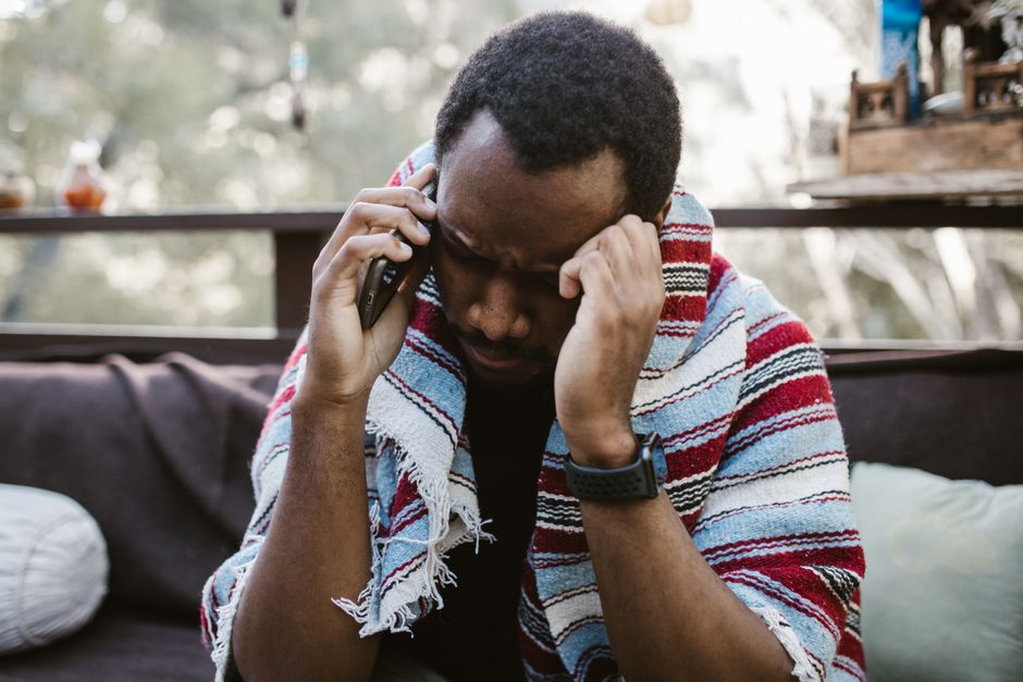 A person holding a phone during a call