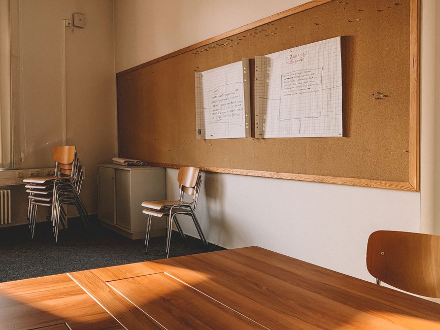 A school board meeting room with members seated at a table