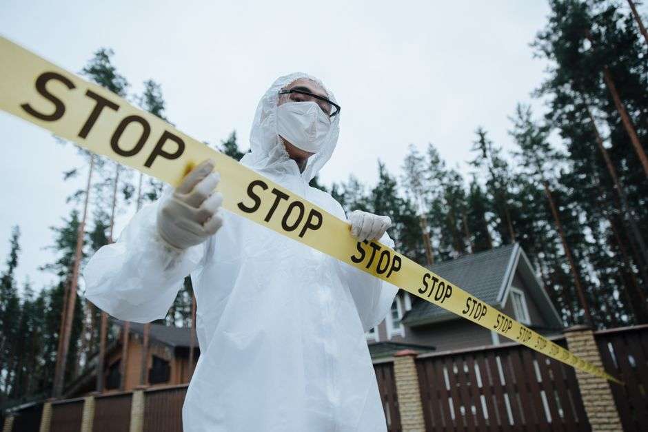 Law enforcement officers at an investigation scene in a wooded area