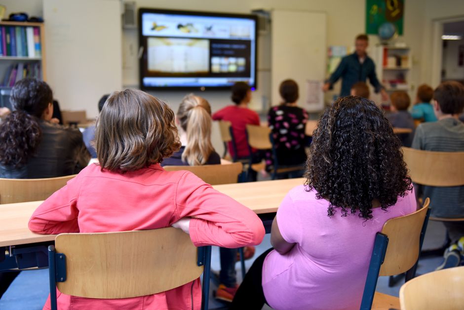 A school board conducting a meeting or interview session