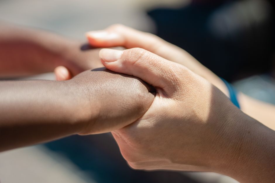 Hands reaching out in a gesture of support and assistance