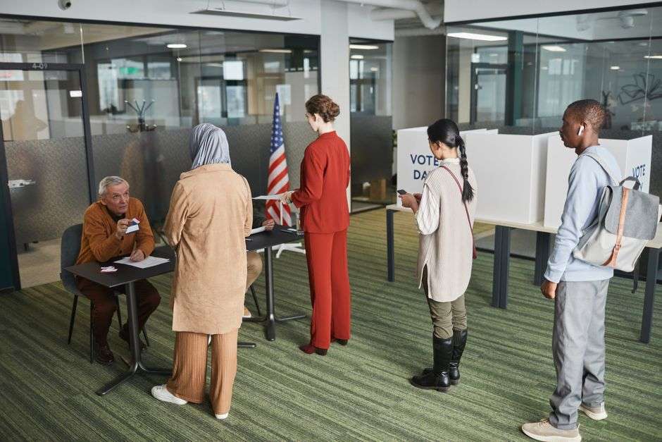 Voters wait in line to cast ballots at a polling station
