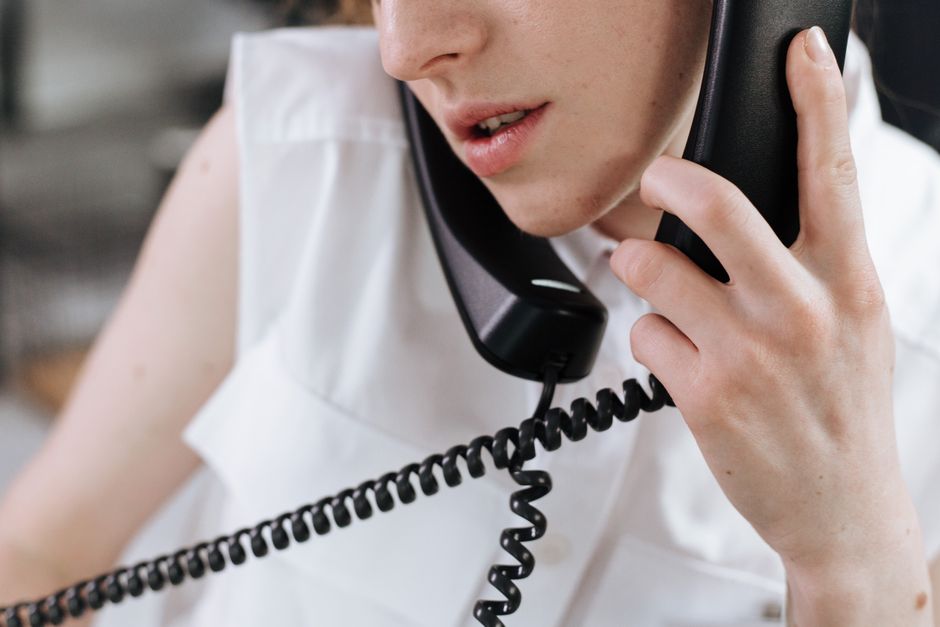 A person holding a phone with a concerned expression