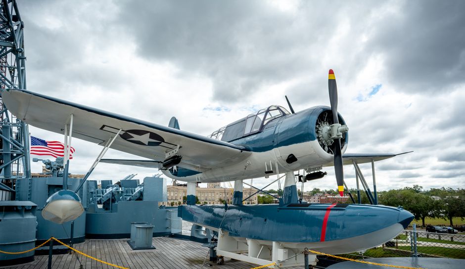 A restored military aircraft on display at a memorial park