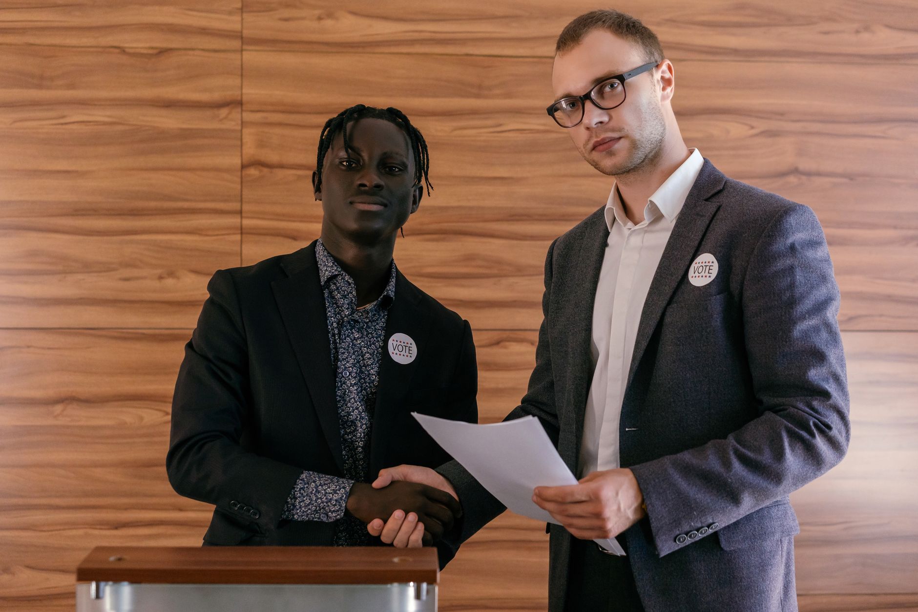 Two people shaking hands at a political campaign event