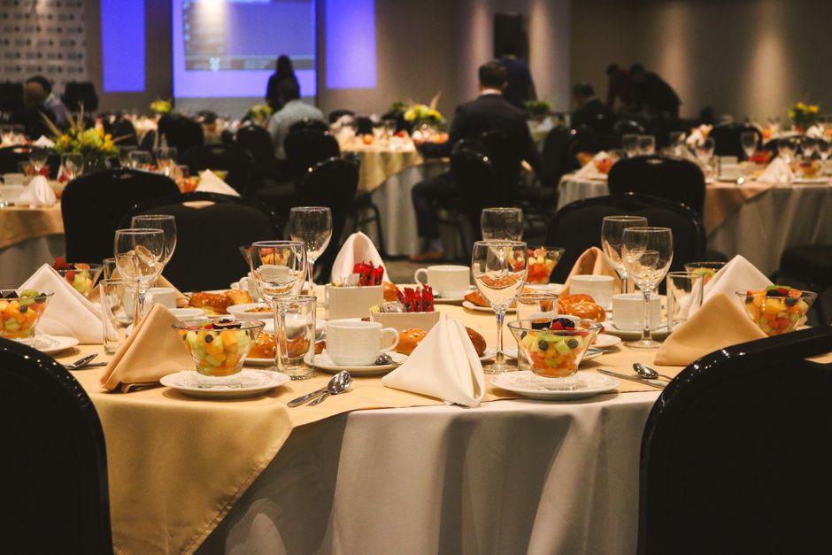 A convention center banquet hall set for a fundraising event