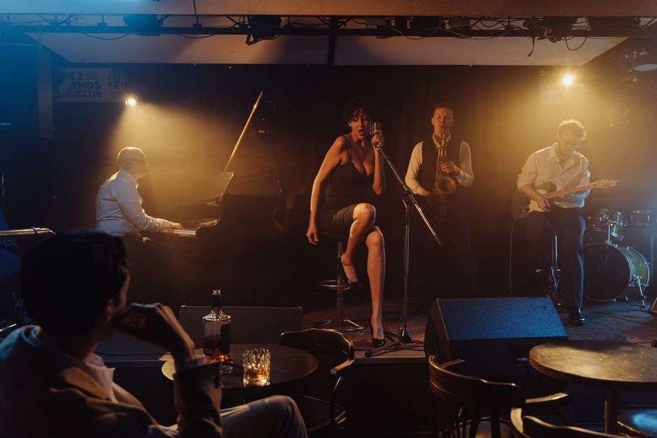 A band performs live soul and blues music on stage in a dimly lit downtown club