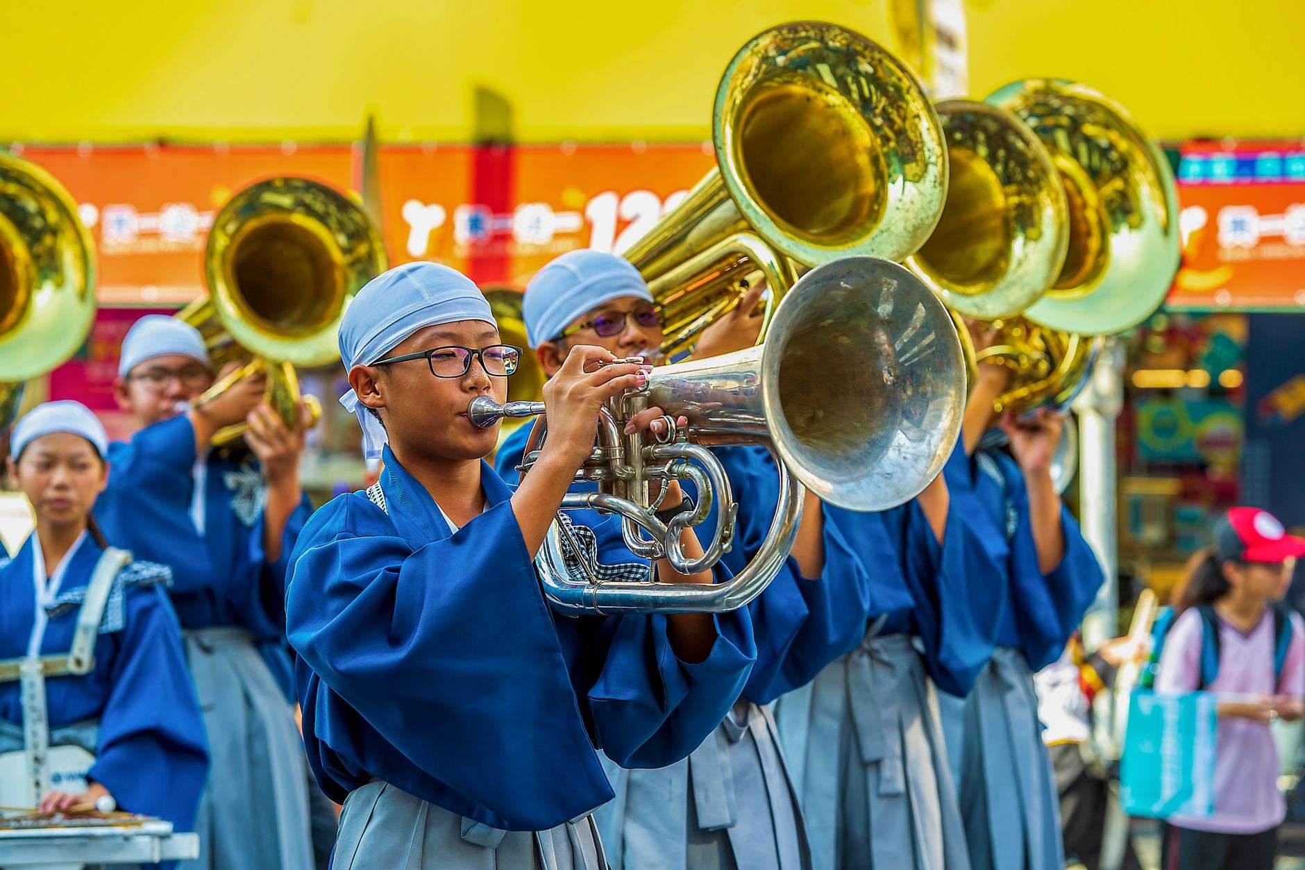 Brass band musicians playing trumpets during a parade
