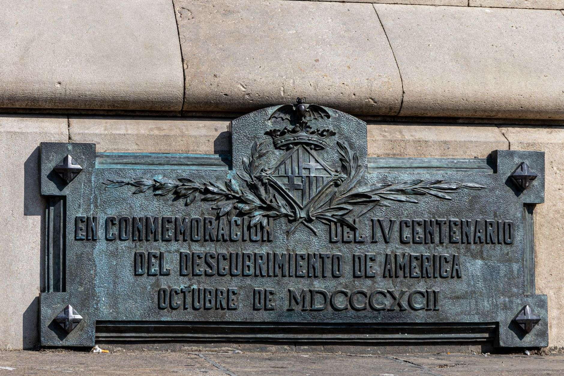 A bronze historical dedication plaque mounted on a wall