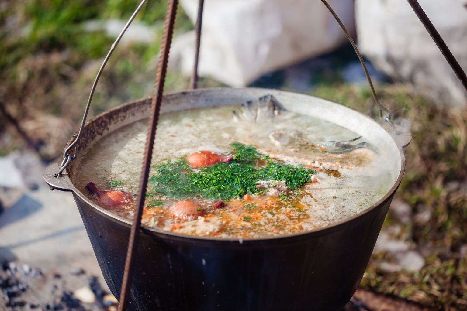 Overhead view of a large pot used for cooking Cajun-style seafood at an outdoor cook-off