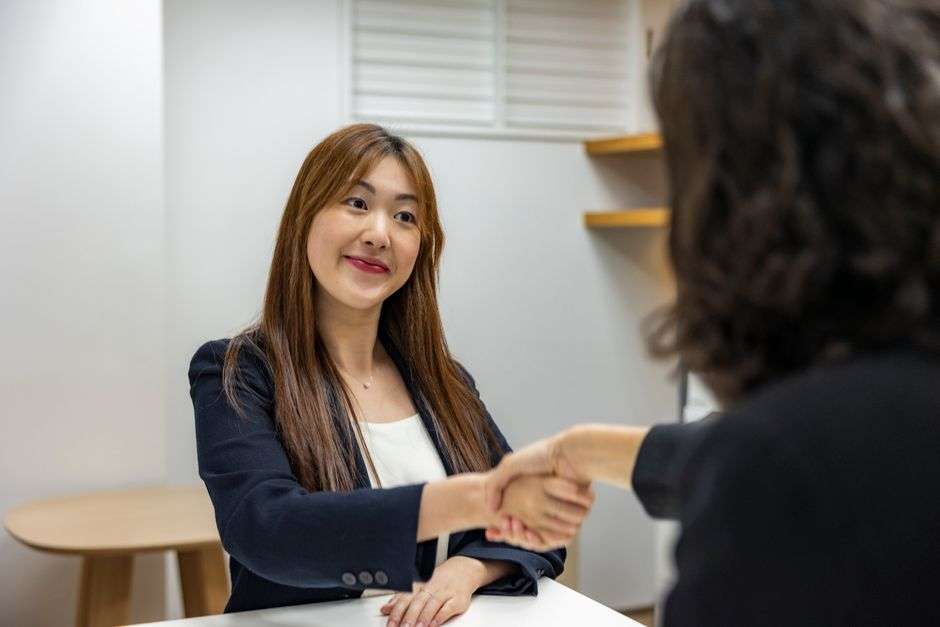 Job seeker shaking hands with a recruiter during a hiring event