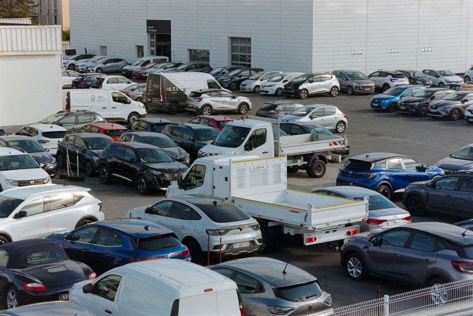 Rows of cars parked at a used car dealership lot