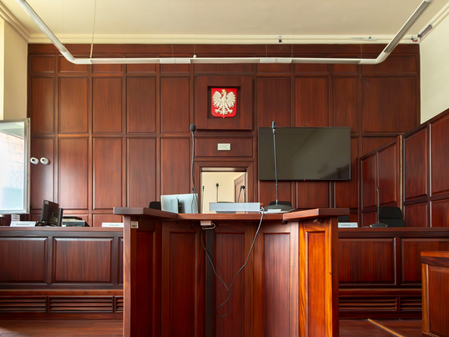 Interior of a courtroom with a wooden judge's bench