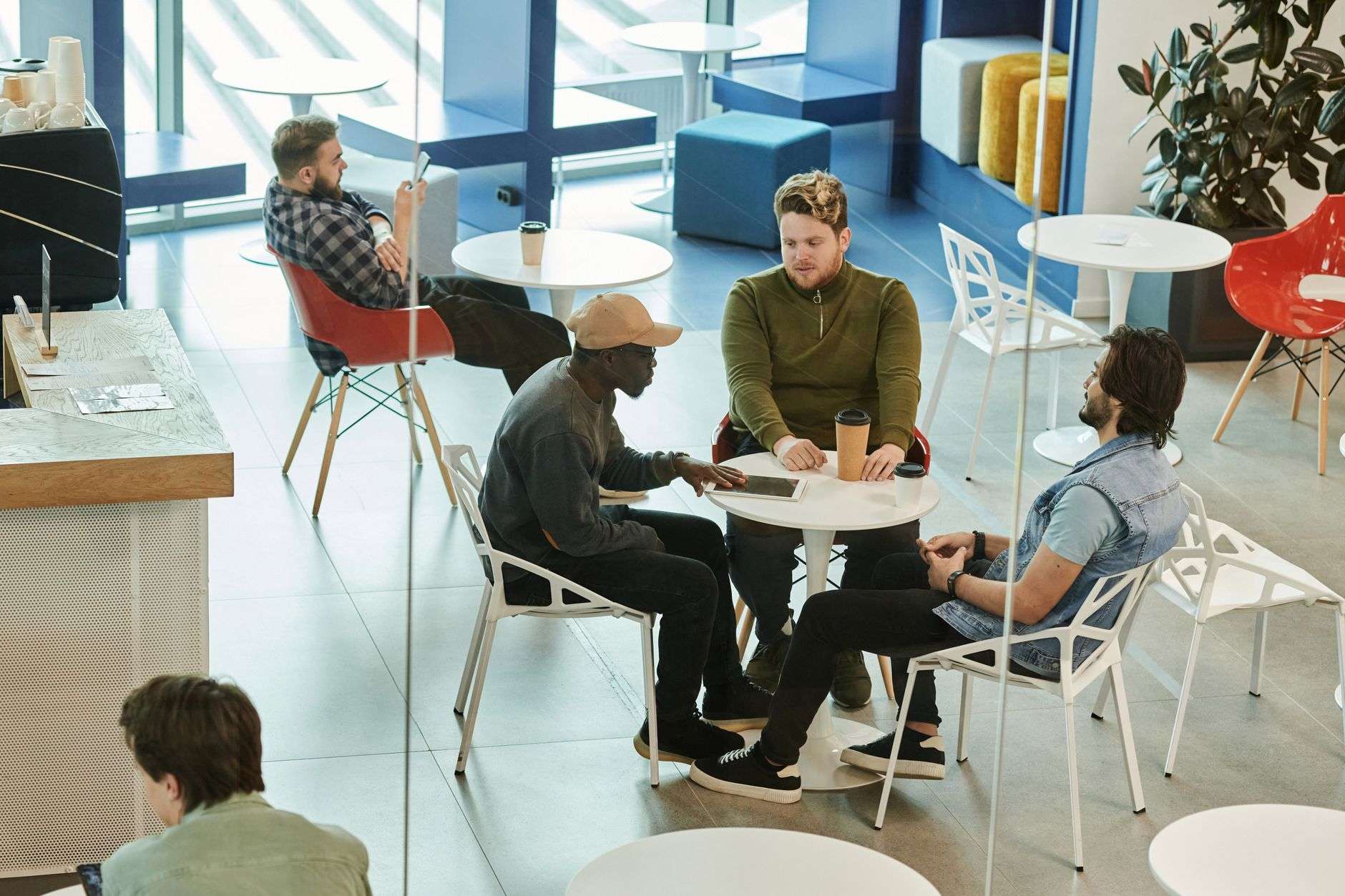 Group of community members having a discussion at a coffee shop table