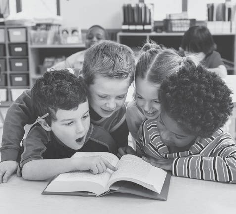 A parent reading a book aloud to a young child