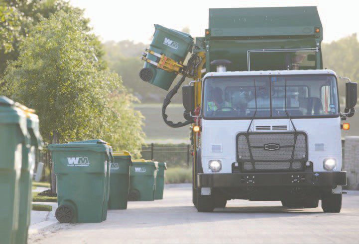 A garbage collection truck making residential pickups