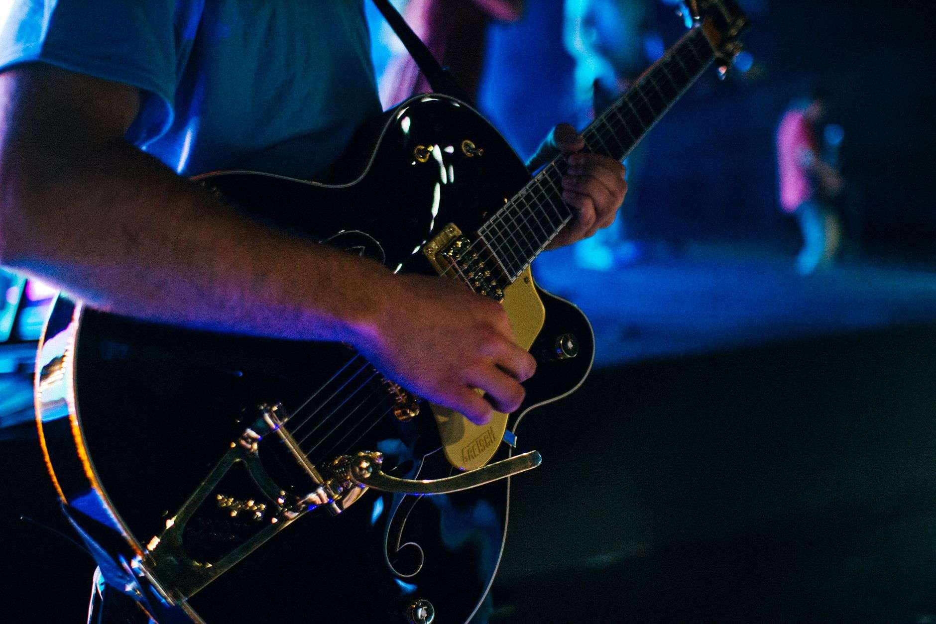Guitarist performing on stage during a classic rock tribute show