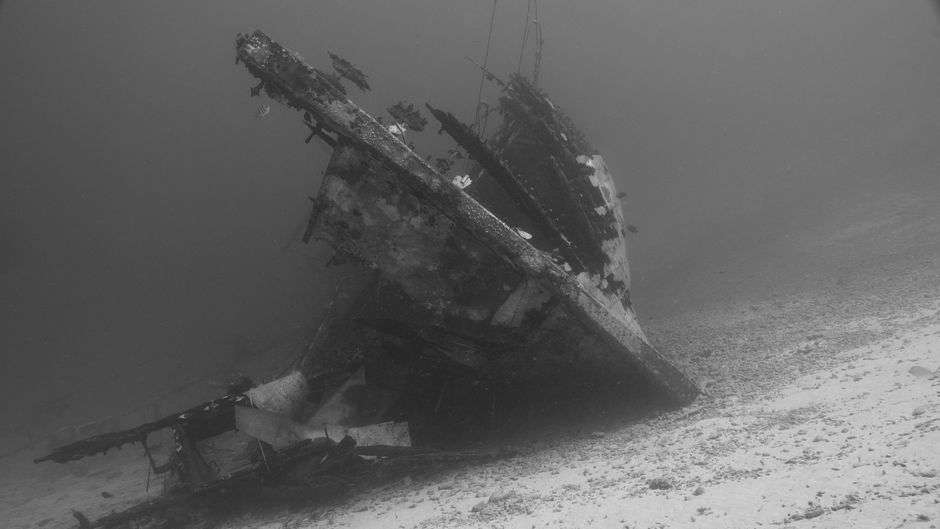 A submerged shipwreck resting on the seabed, similar to historic wrecks preserved underwater