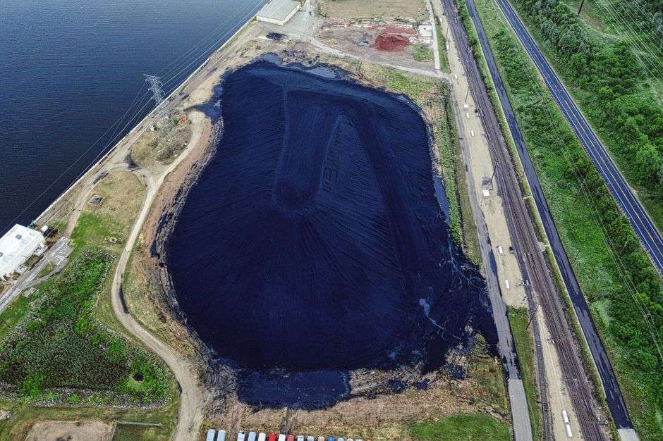 Aerial view of a coal ash containment pond near a coastal power plant