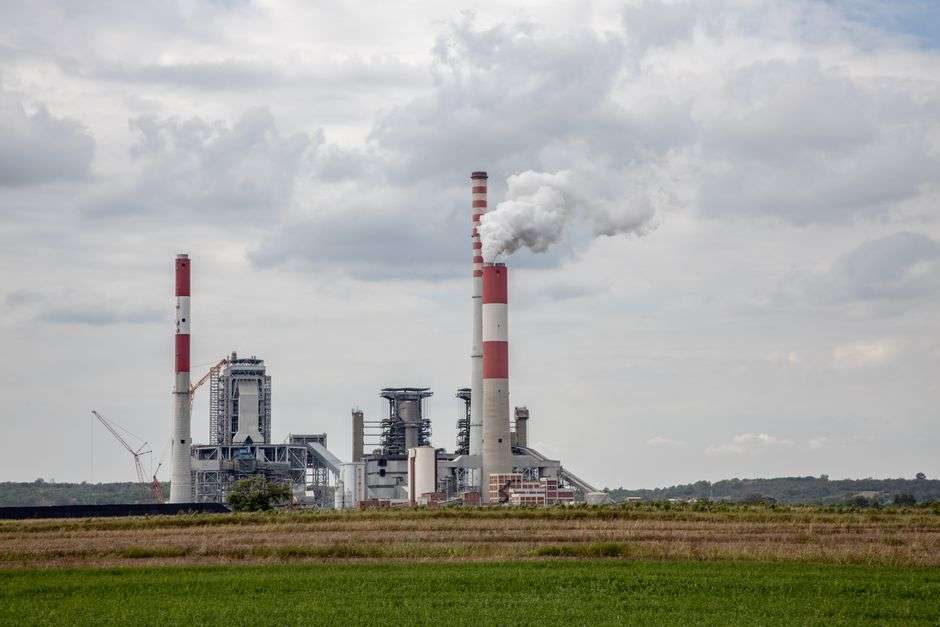 Smokestacks at a coal-fired power plant releasing emissions into the sky