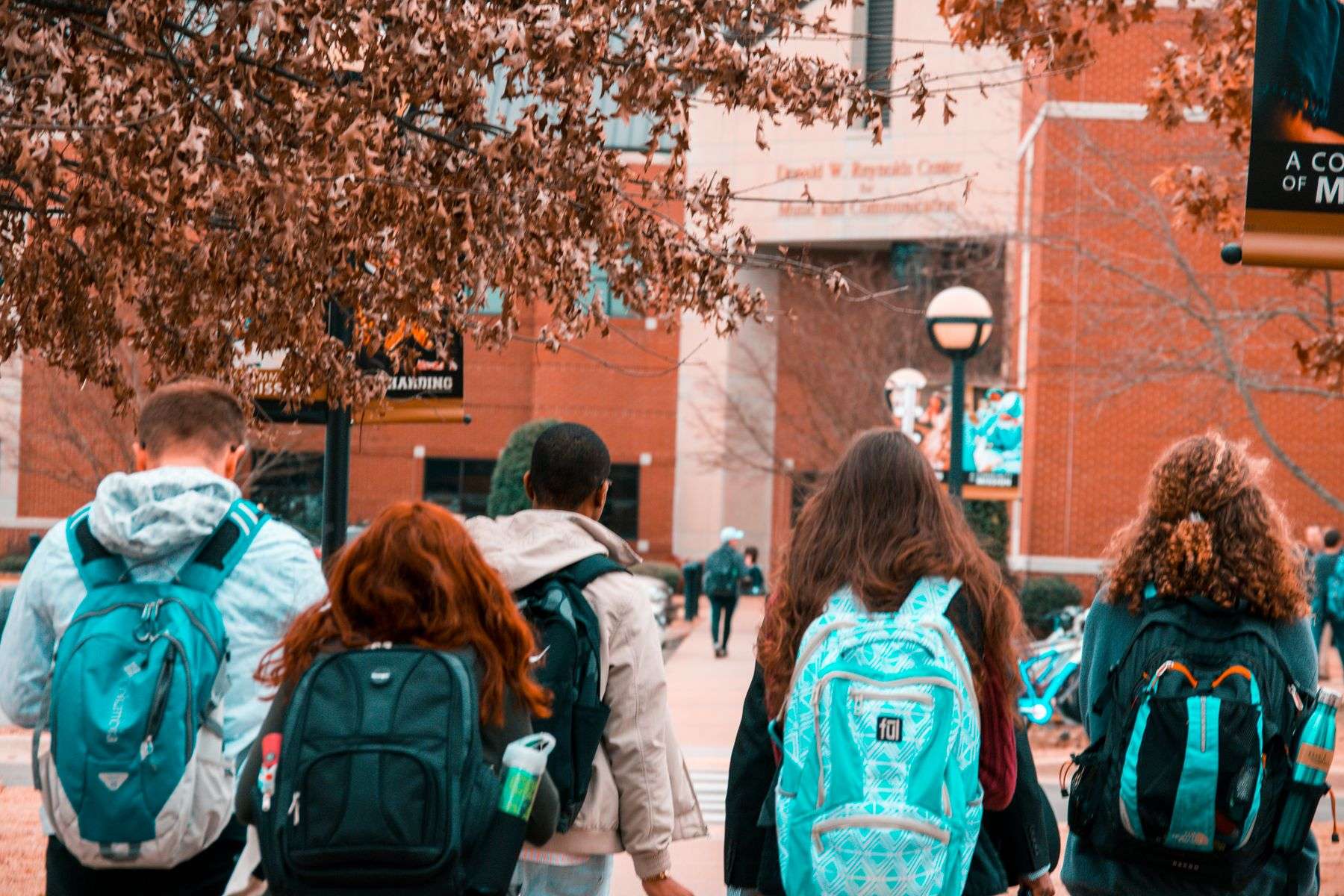 Students with backpacks walking together outdoors on a college campus