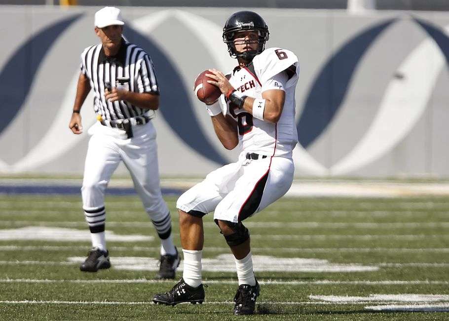 A college football quarterback prepares to throw the ball during a game