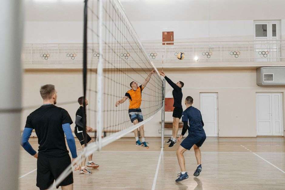 College volleyball players compete during an indoor match