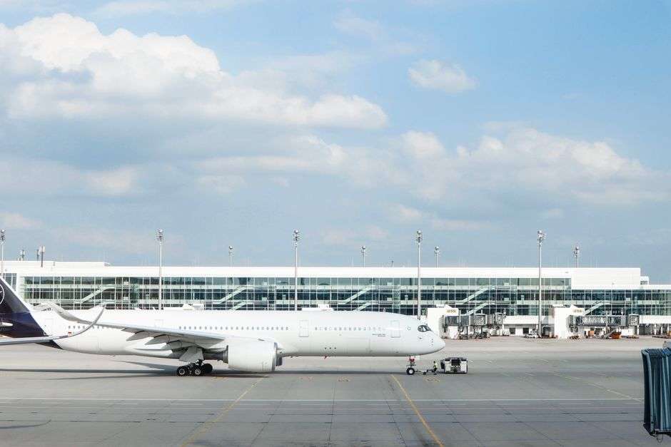 A wide-body commercial jet aircraft parked at an airport terminal gate