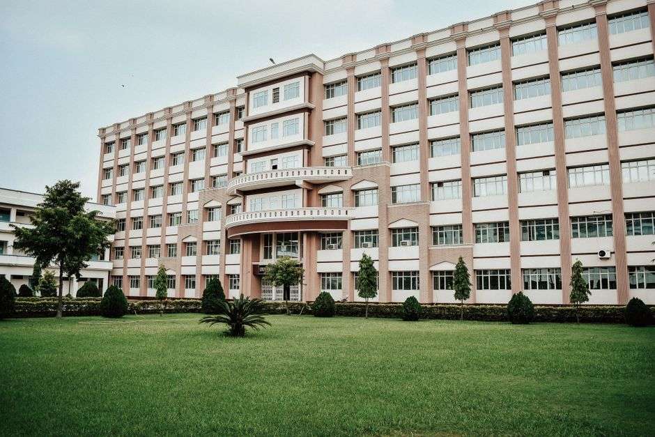 Exterior of a modern community college academic building with a green lawn