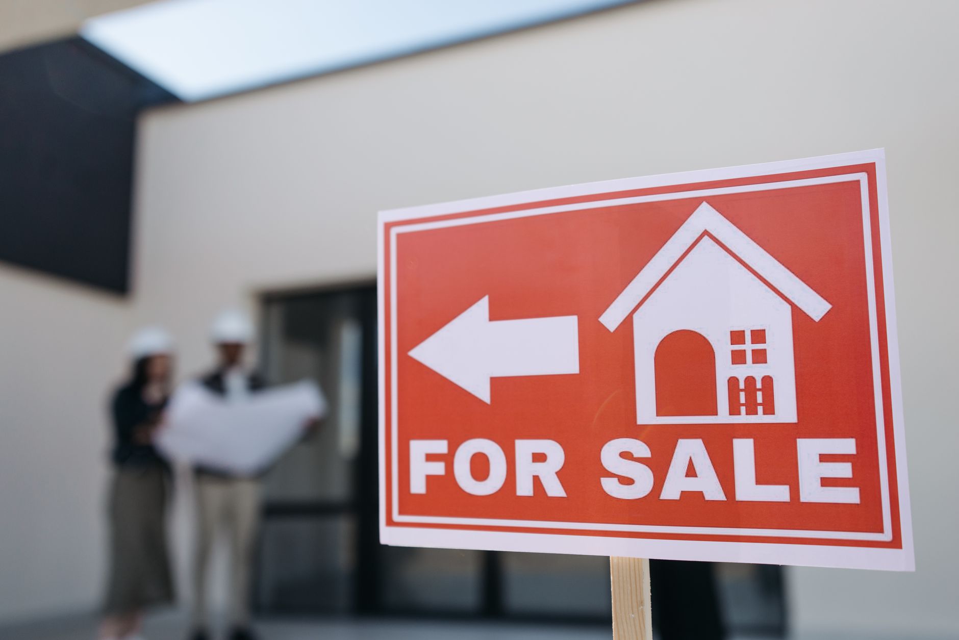 A for-sale sign in front of a Southern home